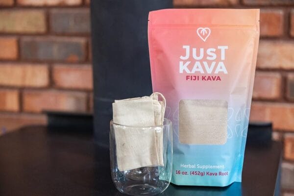 Just Kava Fiji Kava with a strainer and glass